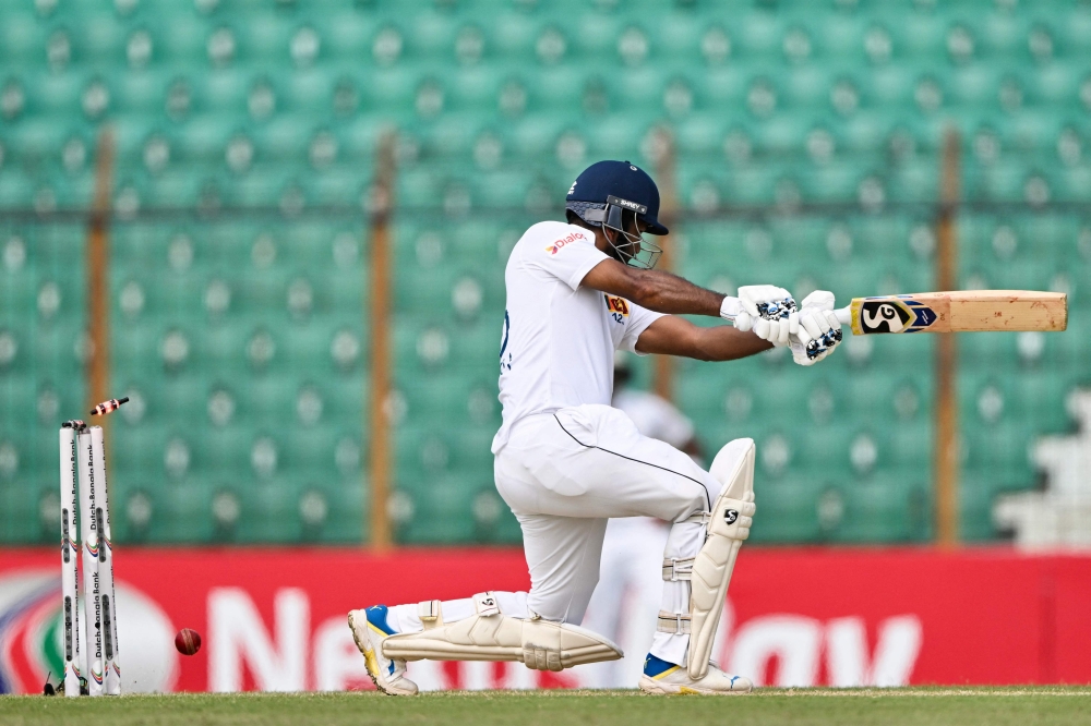Sri Lanka痴 Dimuth Karunaratne is clean bowled by Bangladesh痴 Hasan Mahmud during the first day of the second Test cricket match between Bangladesh and Sri Lanka at the Zahur Ahmed Chowdhury Stadium in Chittagong on March 30, 2024. Photo by MUNIR UZ ZAMAN / AFP.