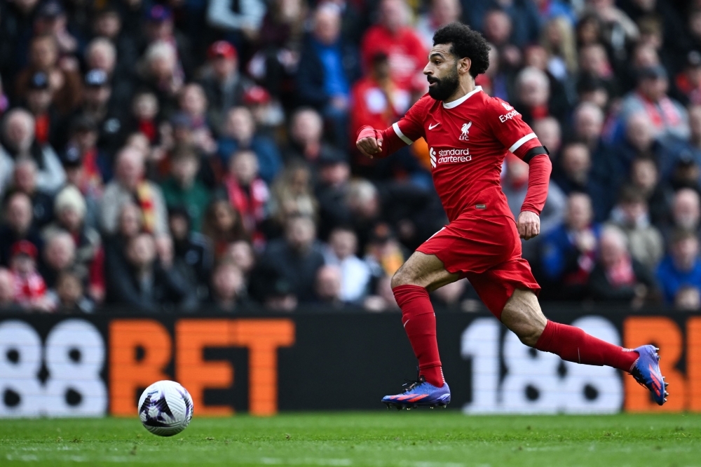 Liverpool's Egyptian striker #11 Mohamed Salah controls the ball during the English Premier League football match between Liverpool and Brighton and Hove Albion at Anfield in Liverpool, north west England on March 31, 2024. Photo by Paul ELLIS / AFP.