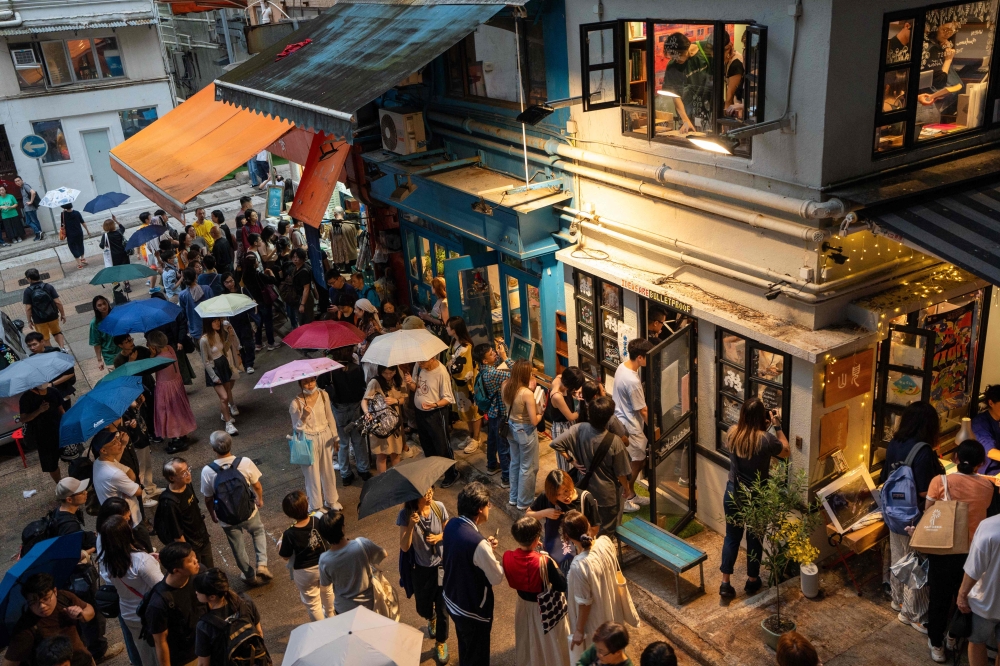Visitors pay tribute to independent bookstore 'Mount Zero' on its last day of business in Hong Kong on March 31, 2024. (Photo by Justin Chan / AFP) 