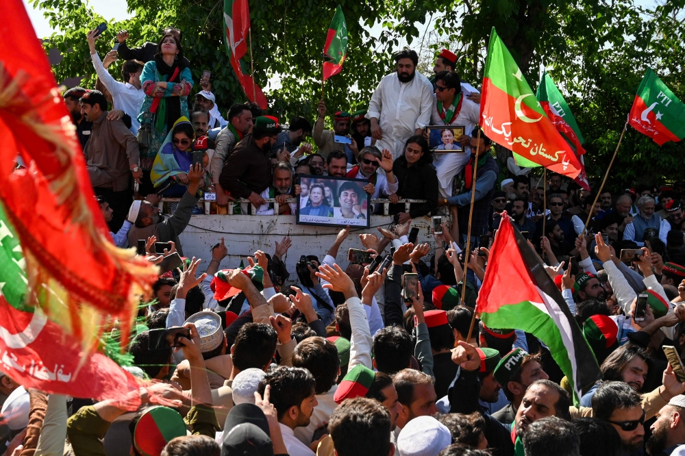 Supporters of former Prime Minister Imran Khan and Pakistan Tehreek-e-Insaf (PTI) party take part in a protest rally for the release of their leader Khan, in Peshawar on March 31, 2024. (Photo by Abdul Majeed / AFP)