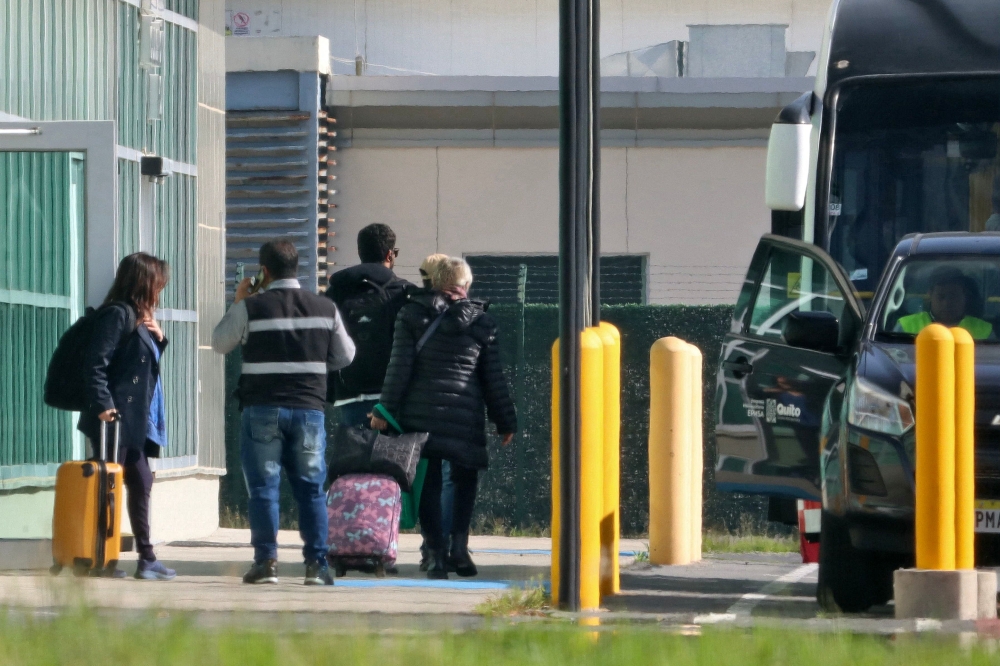 Picture released by API showing Mexico's Ambassador to Ecuador, Raquel Serur Smeke (R), leaving the country at the Mariscal Sucre International Airport in Quito on April 7, 2024. (Photo by Rolando ENRIQUEZ / API / AFP)
