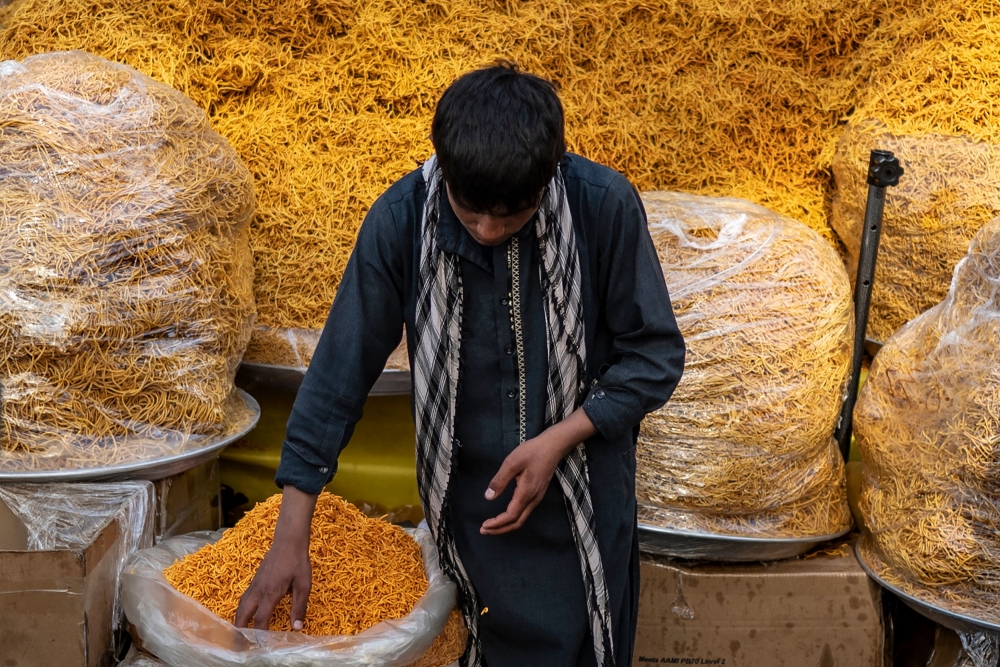 An Afghan vendor selling dry fruits and other eatables waits for customers ahead of Eid al-Fitr, which marks the end of Muslim holy fasting month of Ramadan, at a market in Kabul on April 8, 2024. (Photo by Wakil KOHSAR / AFP)