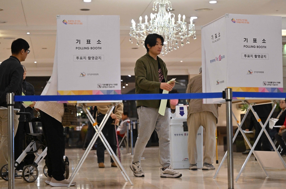 South Koreans cast their ballots during the parliamentary elections at a polling station located in a wedding hall in Seoul on April 10, 2024. (Photo by Jung Yeon-je / AFP)