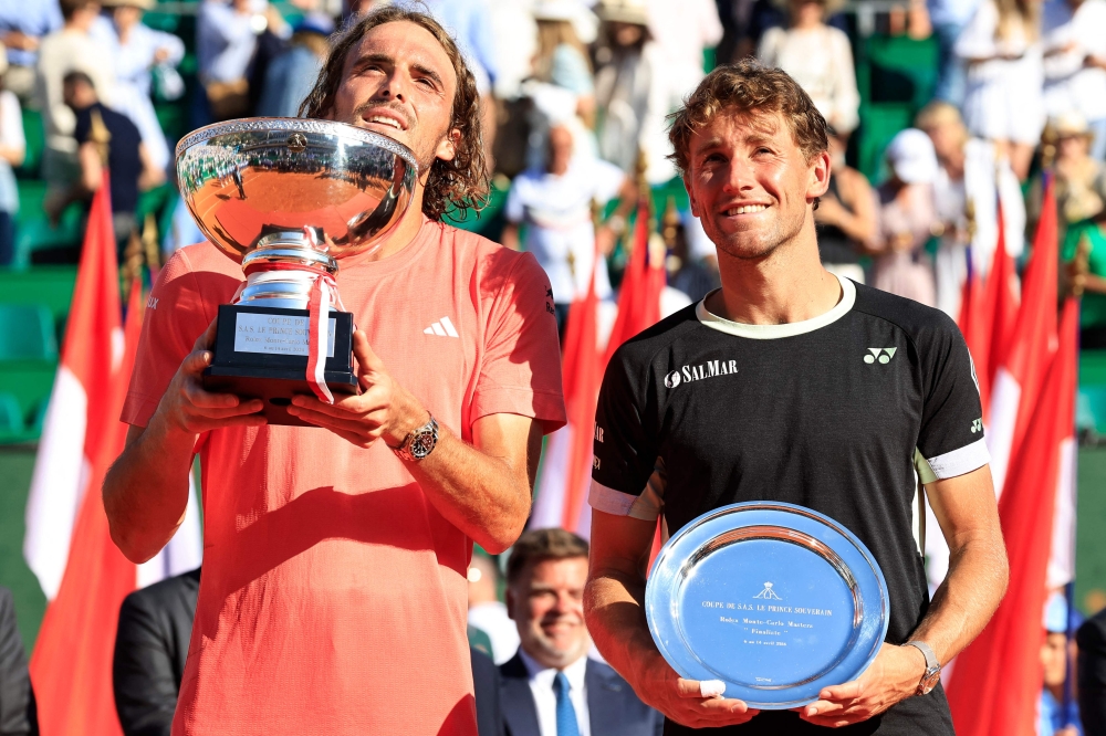 First placed Greece's Stefanos Tsitsipas (L) and second placed Norway's Casper Ruud celebrate with their trophies at the end of their Monte Carlo ATP Masters Series Tournament final tennis match on the Rainier III court at the Monte Carlo Country Club on April 14, 2024. (Photo by Valery HACHE / AFP)
