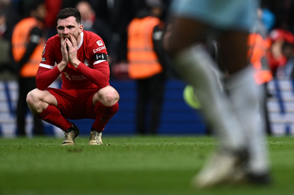 Liverpool's Scottish defender #26 Andrew Robertson reacts to their defeat on the pitch after the English Premier League football match between Liverpool and Crystal Palace at Anfield in Liverpool, north west England on April 14, 2024. Palace won the game 1-0. (Photo by Paul ELLIS / AFP)