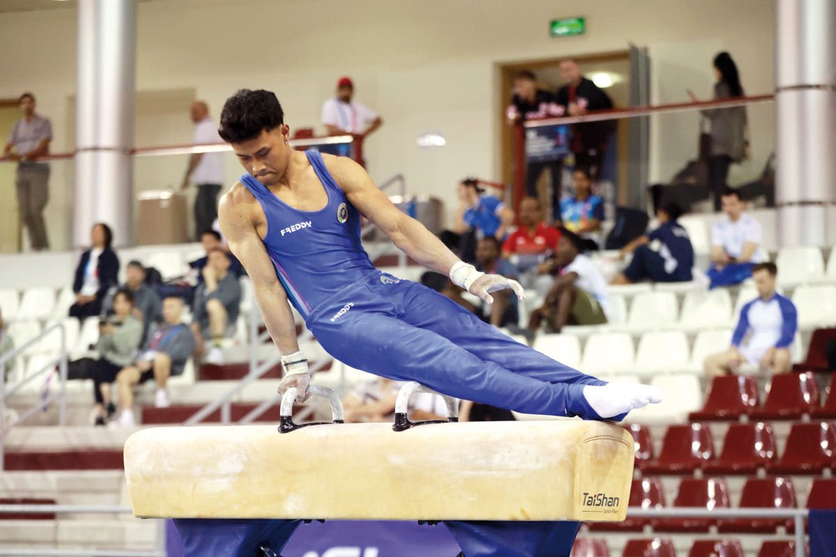 Gymnasts compete during the qualifying rounds yesterday. 