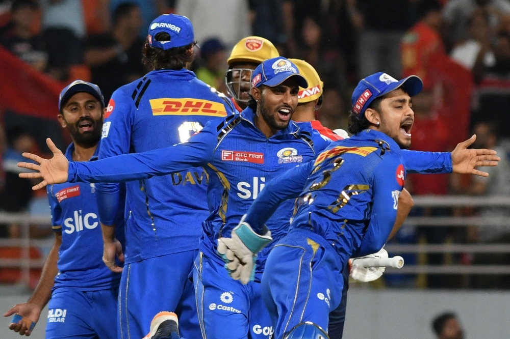 Mumbai Indians' players celebrate their win at the end of the Indian Premier League (IPL) Twenty20 cricket match between Punjab Kings and Mumbai Indians at the Maharaja Yadavindra Singh International Cricket Stadium in Mohali on April 18, 2024. (Photo by AFP)