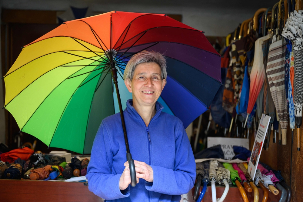 Marija Lah, one of Europe's last umbrella repairers, poses for a photo in her workshop in Ljubljana, Slovenia on March 26, 2024. (Photo by Jure Makovec / AFP)
 