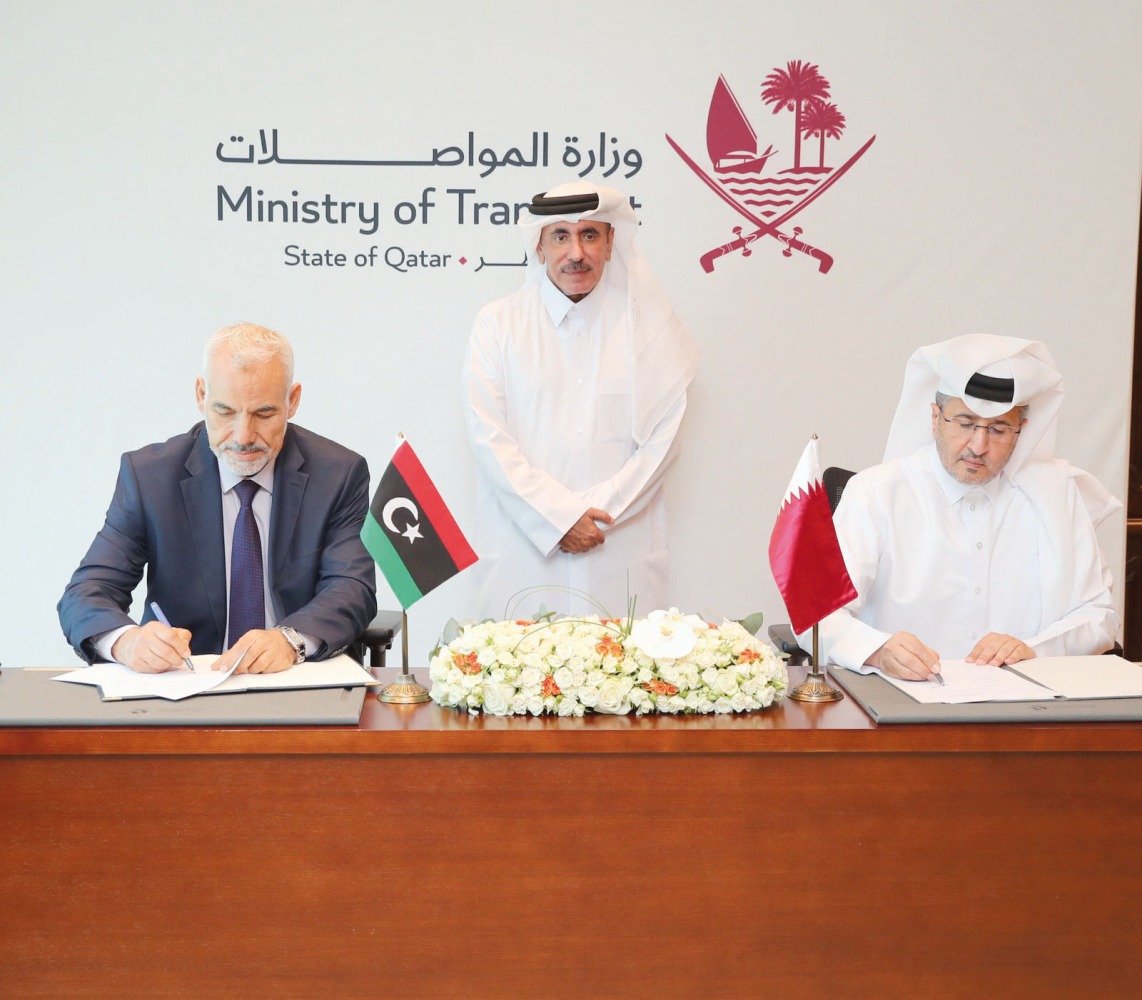 Minister of Transport H E Jassim Saif Ahmed Al Sulaiti (centre) looks on as In charge of managing the Qatar Civil Aviation Authority (QCAA) Mohammed Faleh Alhajri (right) and Head of the Libyan Civil Aviation Authority H E Dr. Mohammed Shalibak sign the agreement.