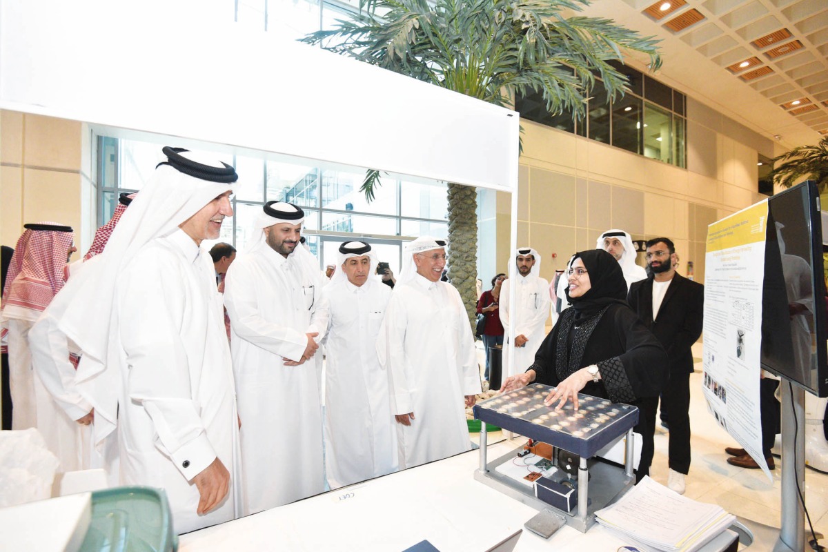 Undersecretary of the Ministry of Education and Higher Education Dr. Ibrahim bin Saleh Al Nuaimi (third left) and President of UDST Dr. Salem Al Naemi (fourth left) touring the exhibition pavillion during the event.