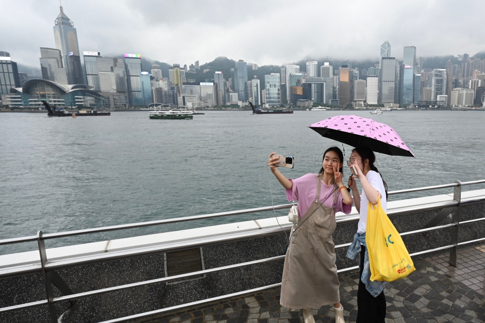 Tourists from mainland China visit the Tsim Sha Tsui waterfront in Hong Kong on May 1, 2024 at the start of the Golden Week holiday period (Photo by Peter Parks / AFP)