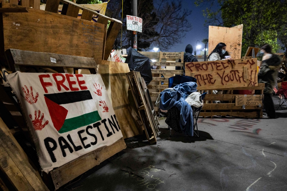 Pro-Palestinian students and activists protest at an encampment in the campus of the University of California, Los Angeles (UCLA) in Los Angeles, California, on May 6, 2024. Photo by Etienne LAURENT / AFP.