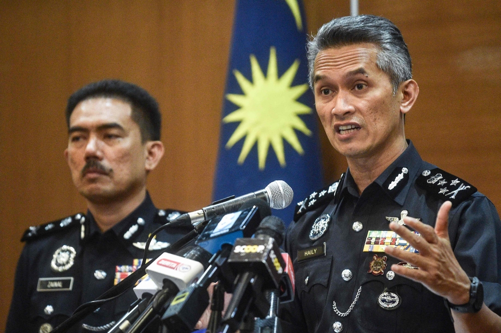 Director of the criminal investigation department of Malaysian police Mohd Shuhaily Mohd Zain (R) speaks during a press conference in Kuala Lumpur on May 8, 2024, after three Malaysian footballers were attacked in a week. Photo by Arif Kartono / AFP