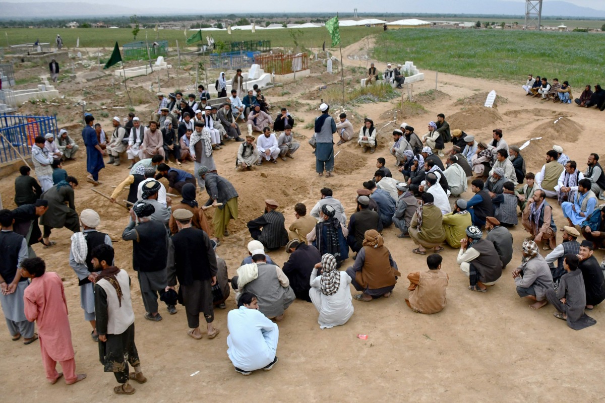 Afghan relatives attend a burial ceremony of victims who lost their lives following flash floods after heavy rainfall at a village in Baghlan-e-Markazi district of Baghlan province on May 11, 2024. (Photo by Atif Aryan / AFP)