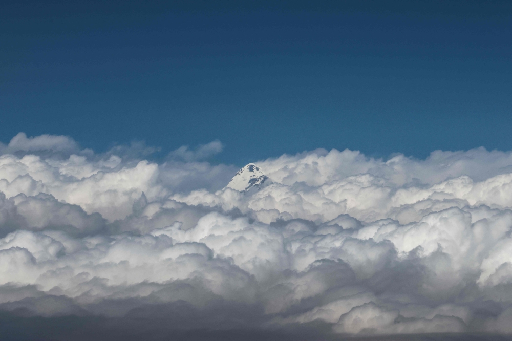 An aerial picture taken midair from an helicopter shows the summit of Mount Makalu, in Nepal's Himalayas range on March 7, 2023. Photo by Sebastien BERGER / AFP