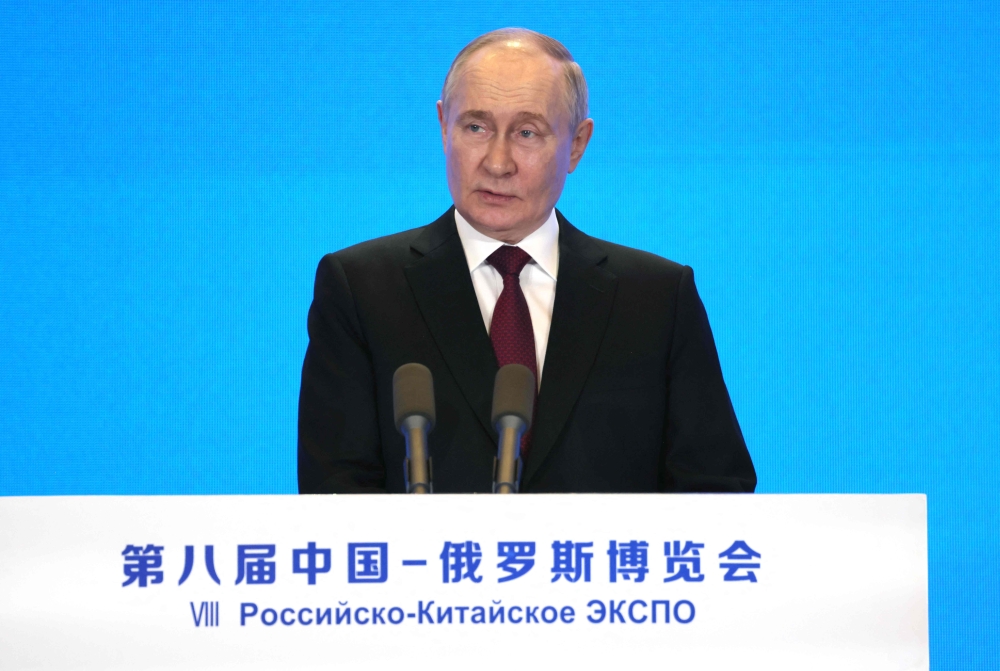 In this pool photograph distributed by the Russian state agency Sputnik, Russia's President Vladimir Putin delivers a speech at the opening ceremony of a Russia-China trade expo in the northeastern city of Harbin on May 17, 2024. (Photo by Mikhail Metzel / POOL / AFP)