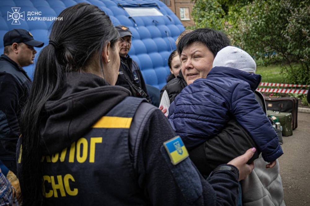 This handout photograph taken and released by Ukrainian Emergency Service on May 17, 2024, shows rescuers evacuating civilians from Russian shelling in Kharkiv region. (Photo by Handout / Ukraine Emergency Service / AFP) 