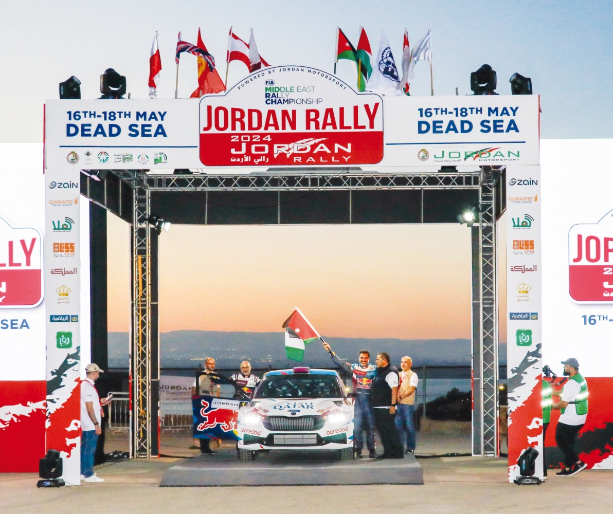 File photo of Qatar's Nasser Saleh Al Attiyah waves a flag at the start of the Jordan Rally
