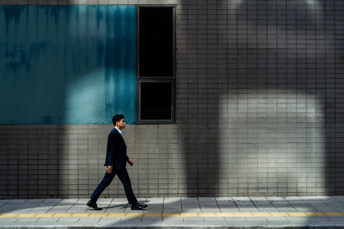 A man walks along a pavement in Seoul on May 14, 2024. (Photo by ANTHONY WALLACE / AFP)
