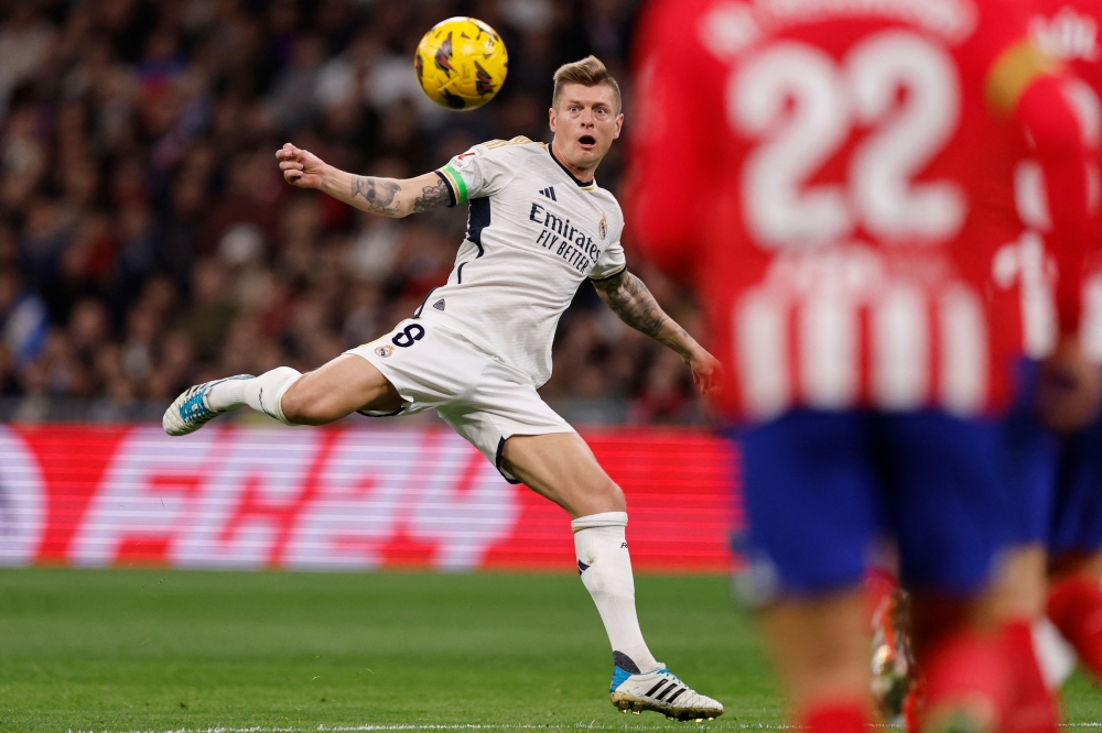 Real Madrid's German midfielder #08 Toni Kroos stares at the ball during the Spanish league football match between Real Madrid CF and Club Atletico de Madrid at the Santiago Bernabeu stadium in Madrid on February 4, 2024. Photo by OSCAR DEL POZO / AFP