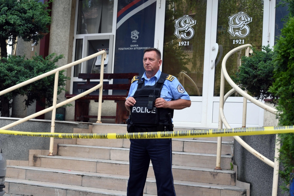 A Kosovan police officer guards an office of 