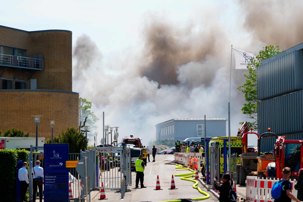 Firemen work to extinguish a fire that broke out at the headquarters of Danish multinational pharmaceutical company Novo Nordisk in Bagsvaerd near Copenhagen, Denmark, on May 22, 2024. Photo by Liselotte Sabroe / Ritzau Scanpix / AFP