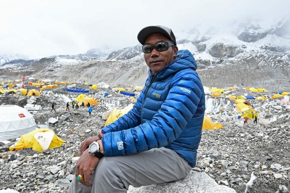 In this photograph taken on May 2, 2021, Nepali mountaineer Kami Rita Sherpa poses during an interview with AFP at Everest base camp in the Mount Everest region of Solukhumbu district. Photo by Prakash MATHEMA / AFP