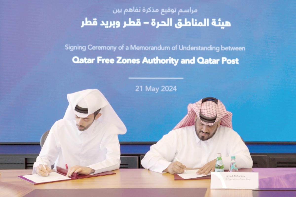Abdulla Hamad Al Binali, Director of Investor Relations & Technical Support at QFZ, and Hamad Al Fahida, Chief Operating Officer of Qatar Post during the MoU signing.