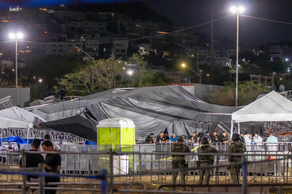 The debris is seen covered with a tarp after a stage collapsed during a campaign rally for Mexican presidential candidate Jorge Alvarez Maynez in San Pedro Garza Garcia, Nuevo Leon, Mexico, on May 22, 2024. (Photo by Julio Cesar Aguilar / AFP)