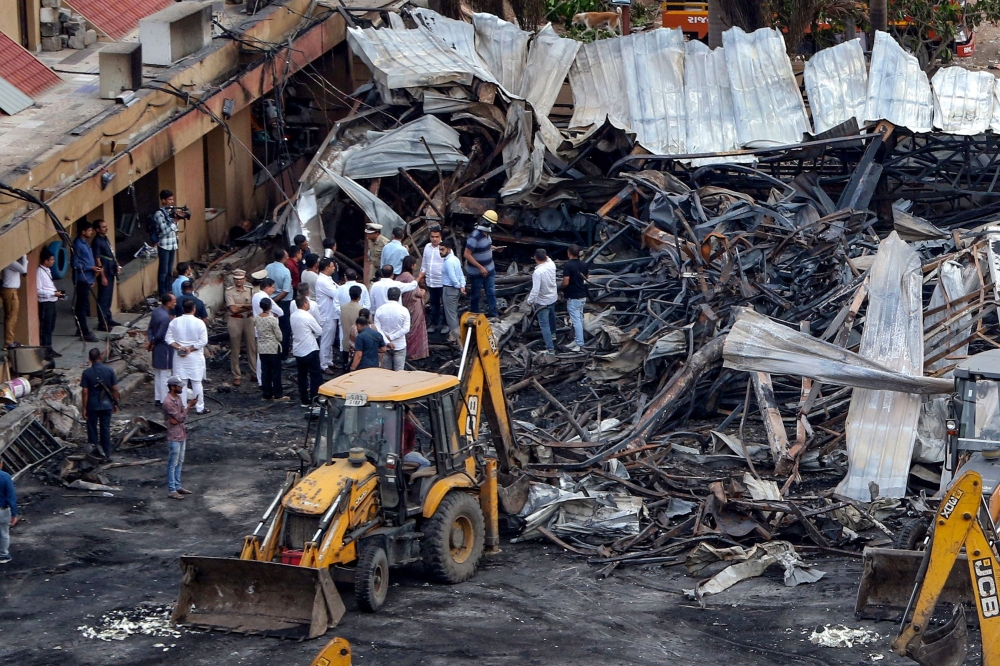 Officials inspect the site of a fire accident on the following day of the disaster, at an amusement park facility in Rajkot, in India's Gujarat state on May 26, 2024. Photo by AFP