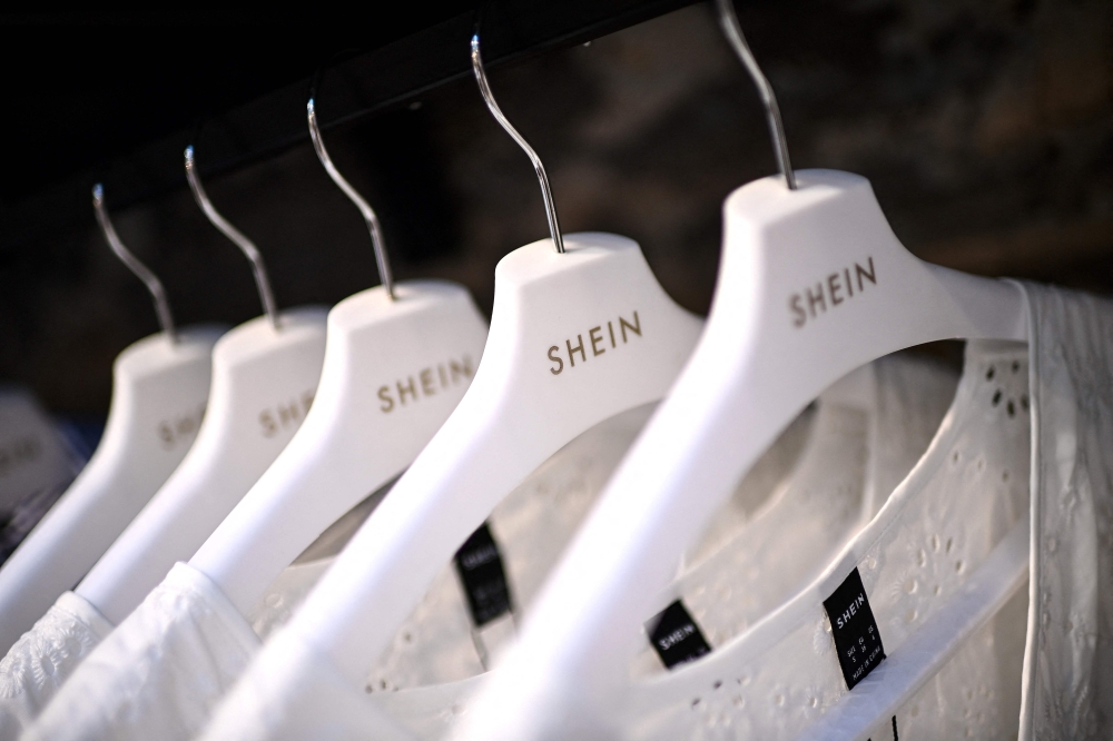 Clothes are displayed on hangers at a Chinese fashion brand Shein pop-up store in Paris on May 4, 2023. (Photo by Christophe Archambault / AFP)