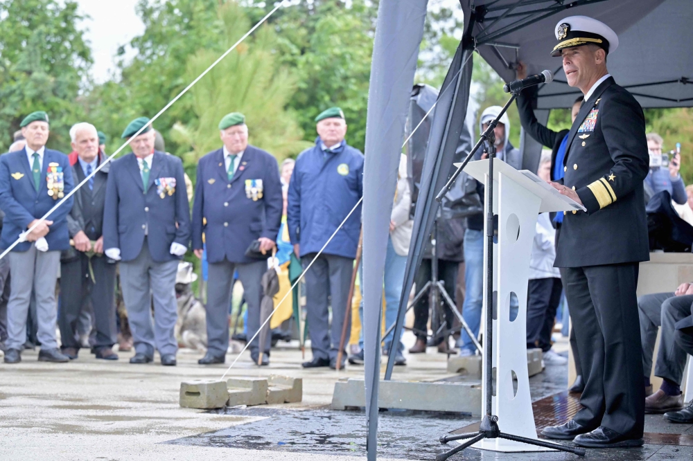 Rear Amiral Keith B. Davids gives a speech during the inauguration of a new monument dedicated to the NCDUs (Naval Combat Demolition Units) and Scouts and Raiders (Scouts et Commandos) on May 30, 2024 at Omaha Beach, Saint-Laurent-sur-Mer, northwestern France, as part of the commemoration of the 80th anniversary of D-Day. Photo by LOU BENOIST / AFP.