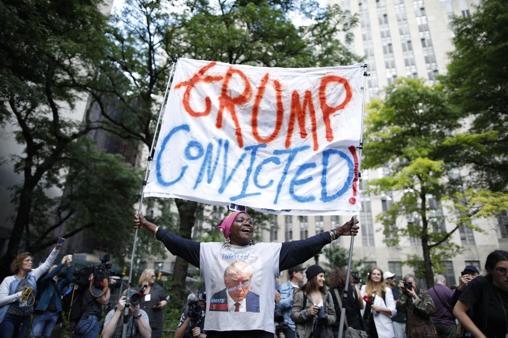 People react after former US President and Republican presidential candidate Donald Trump was convicted in his criminal trial outside of Manhattan Criminal Court in New York City, on May 30, 2024. (Photo by Kena Betancur / AFP)