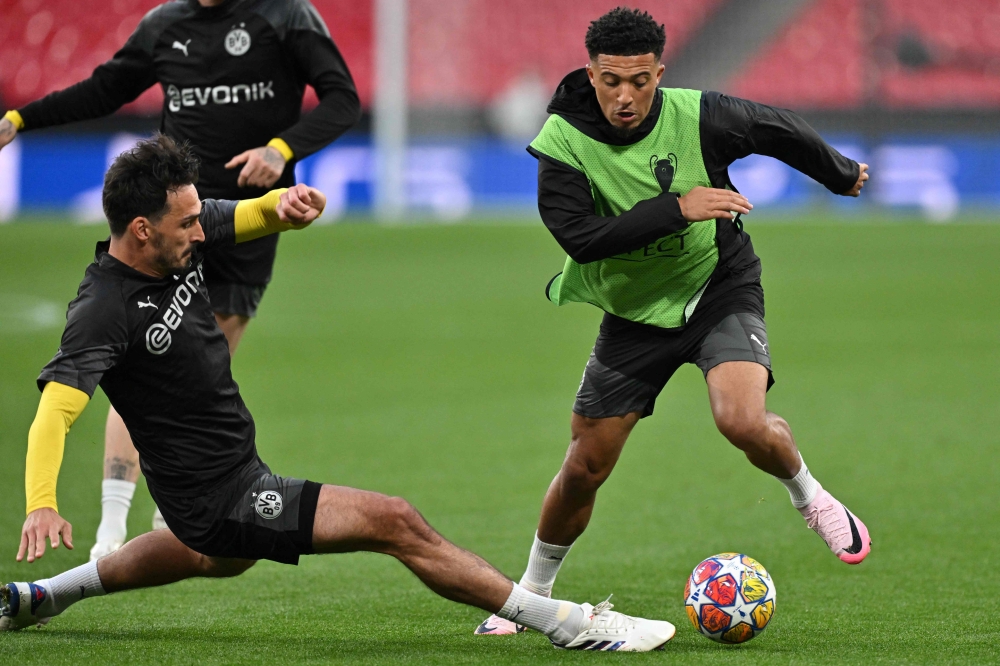 Dortmund's English midfielder #10 Jadon Sancho is tackled by Dortmund's German defender #15 Mats Hummels during a training session at Wembley stadium, in London, on May 31, 2024. (Photo by Glyn Kirk / AFP)