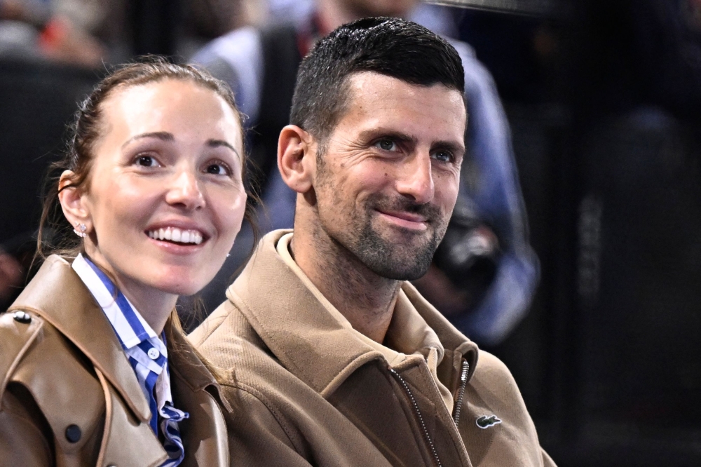 Serbia's tennis player Novak Djokovic (R) and his wife Jelena Djokovic attend the Starligue match PSG vs Aix-en-Provence at Accor Arena stadium in Paris on May 31, 2024. (Photo by Julien De Rosa / AFP)