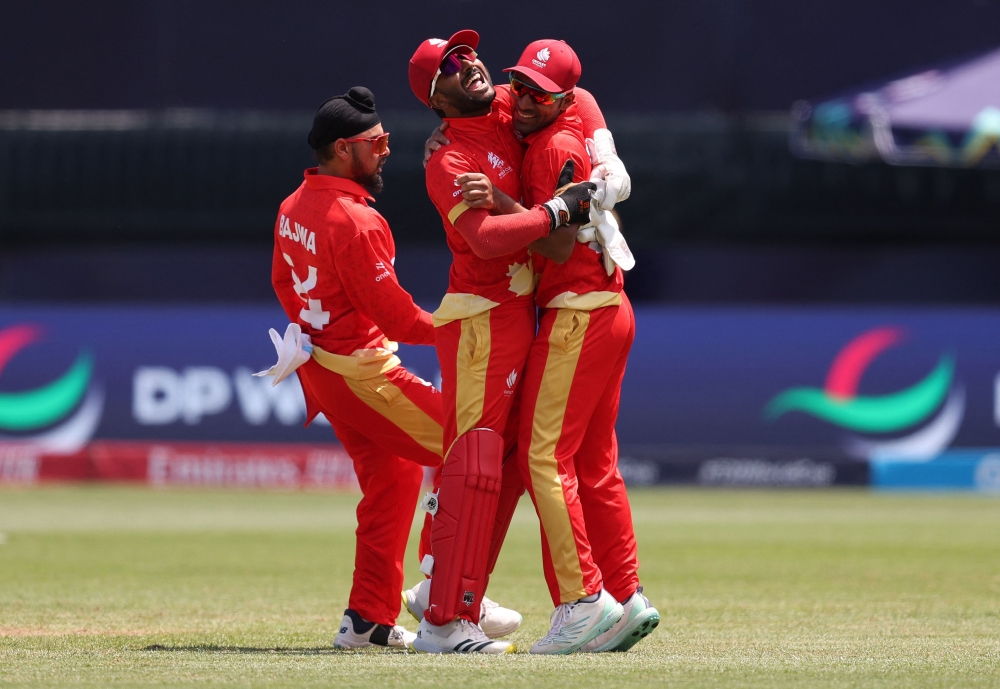 Dilpreet Bajwa, Shreyas Movva and Saad Bin Zafar of Canada celebrate after the team's victory during the ICC Men's T20 Cricket World Cup West Indies & USA 2024 match between Canada and Ireland at Nassau County International Cricket Stadium on June 7, 2024 in New York, New York. (Photo by Robert Cianflone/Getty Images/AFP)

