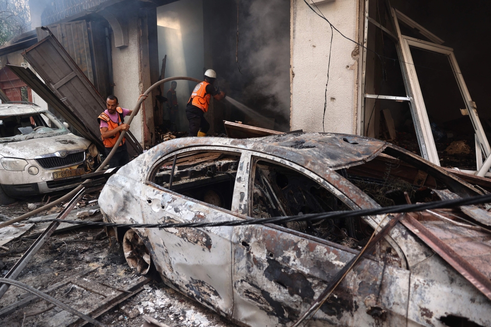Palestinian firefighters battle a flame a day after an operation by the Israeli Special Forces in the Nuseirat camp, in the central Gaza Strip on June 9, 2024. (Photo by Eyad Baba / AFP)