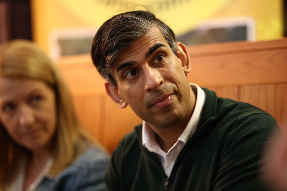 Britain's Prime Minister and Conservative Party leader, Rishi Sunak meets with Neighbourhood Watch representatives in Horsham, south of London on June 10, 2024. (Photo by Henry Nicholls / Pool / AFP)
