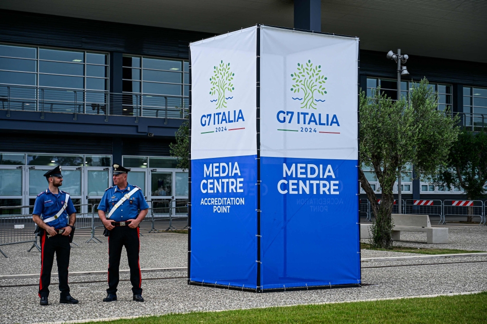Police officers stand outside the G7 Italy 2024 media centre in Bari, Italy, on June 11, 2024. (Photo by Piero Cruciatti / AFP)

