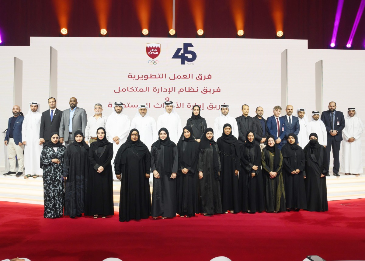 QOC Secretary General Jassim bin Rashid Al Buenain and other QOC officials pose for a group photo during the ceremony.