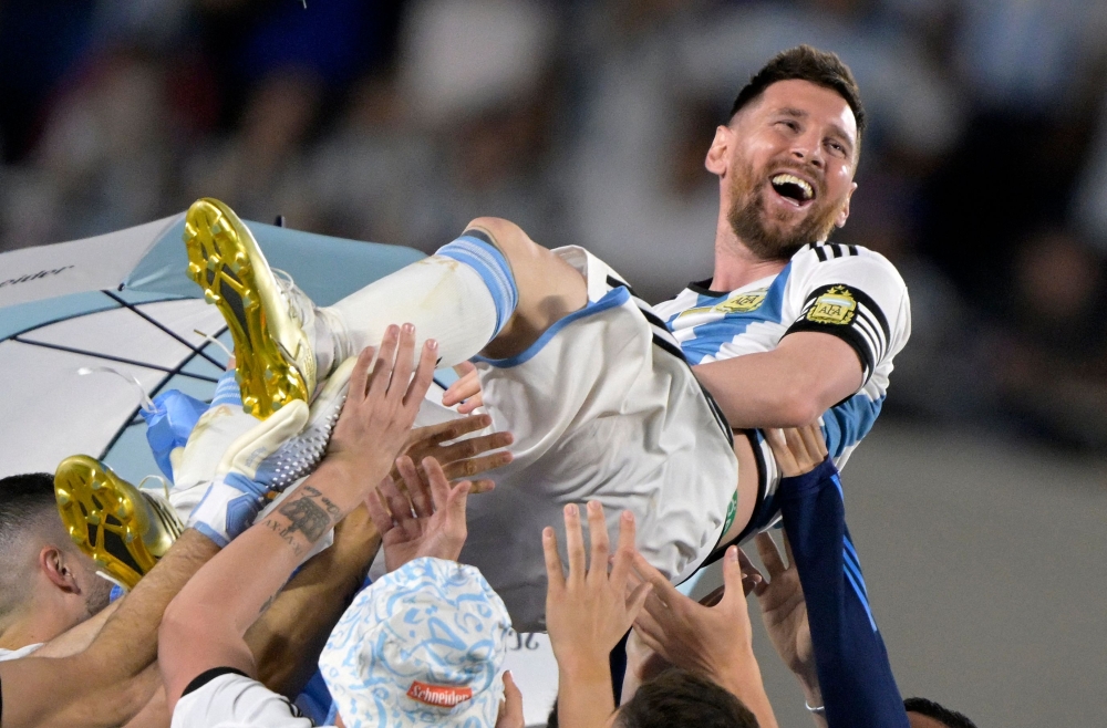 File:  Argentina's forward Lionel Messi is thrown up in the air by teammates during a recognition ceremony for the World Cup winning players, following the friendly football match between Argentina and Panama at the Monumental stadium in Buenos Aires on March 23, 2023. (Photo by Juan Mabromata / AFP)
