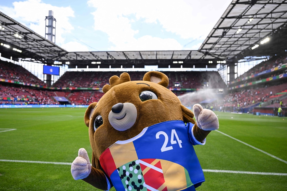 Mascot of the UEFA Euro 2024 'Albaert' poses prior to the UEFA Euro 2024 Group A football match between Hungary and Switzerland at the Cologne Stadium in Cologne on June 15, 2024. (Photo by Kirill Kudryavtsev / AFP)