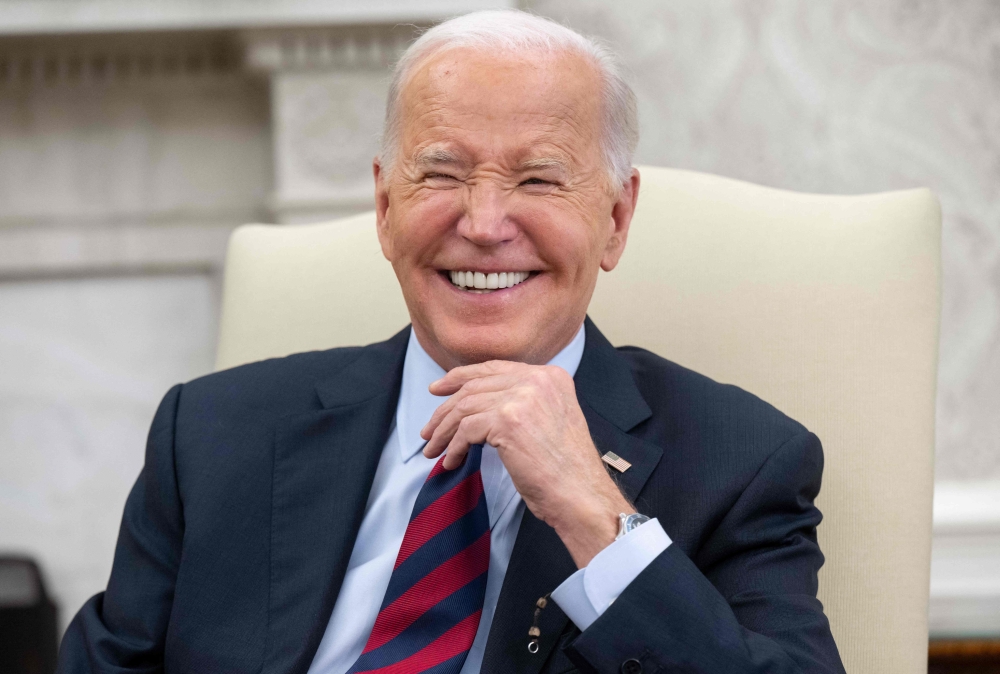 US President Joe Biden laughs during a bilateral meeting with Secretary General Jens Stoltenberg of NATO in the Oval Office of the White House in Washington, DC, June 17, 2024. (Photo by Saul Loeb / AFP)
