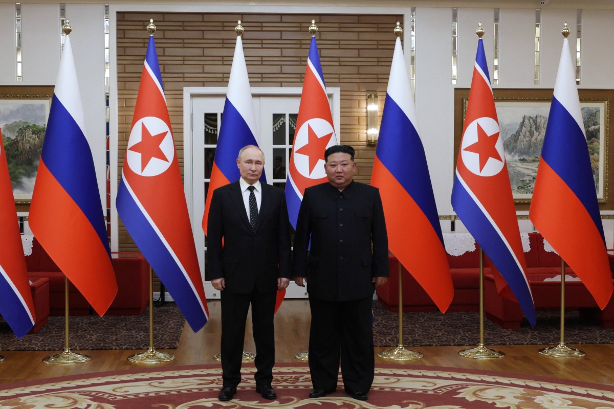 In this pool photograph distributed by the Russian state agency Sputnik, North Korea's leader Kim Jong Un (R) and and Russian President Vladimir Putin pose after a welcoming ceremony at Kim Il Sung Square in Pyongyang on June 19, 2024. Photo by Gavriil GRIGOROV / POOL / AFP.