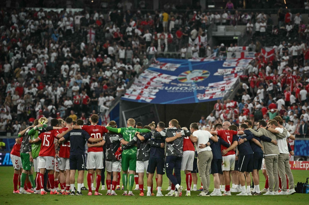 Denmark players react after the UEFA Euro 2024 Group C football match between Denmark and England at the Frankfurt Arena in Frankfurt am Main on June 20, 2024. (Photo by Angelos Tzortzinis / AFP)
