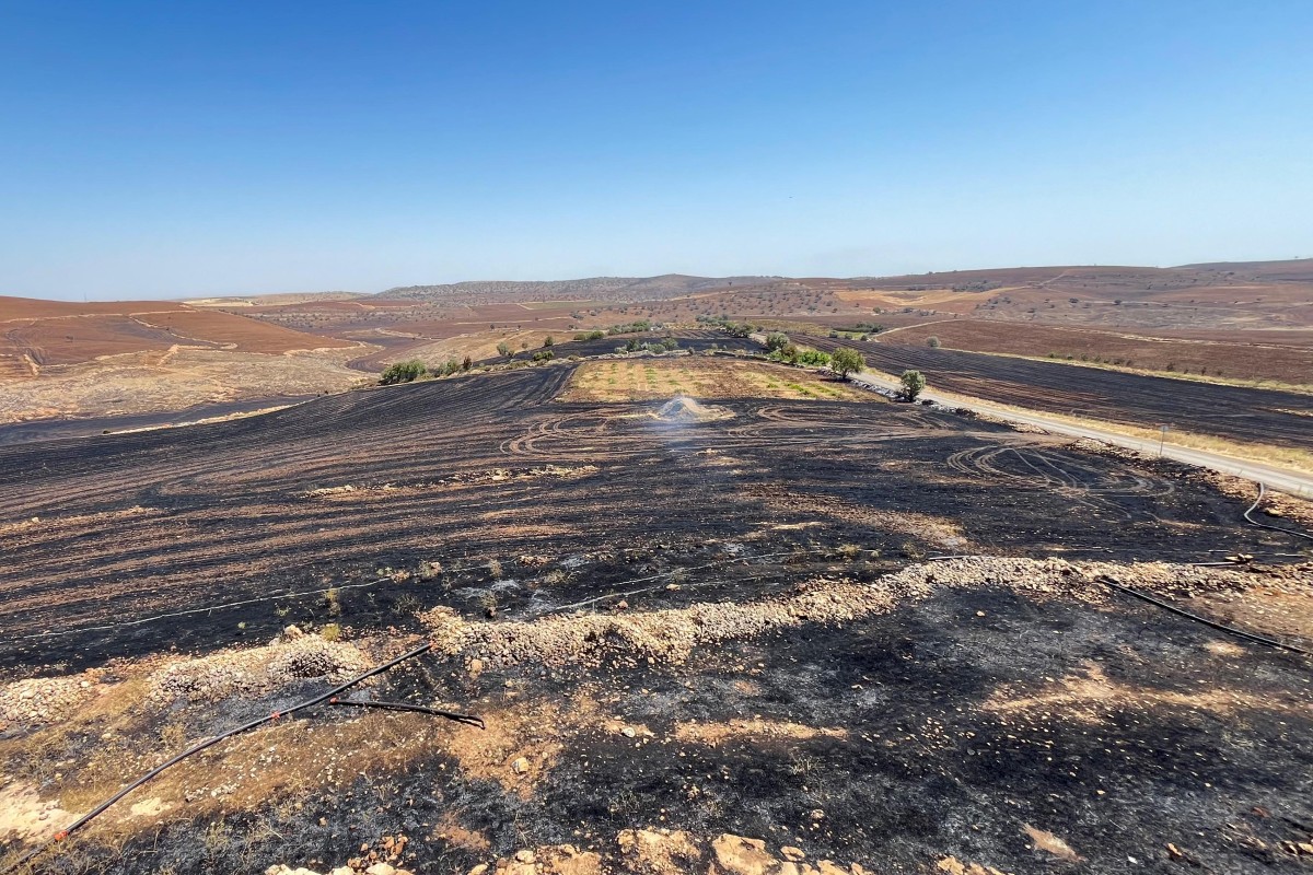 This handout photograph taken and released on June 21, 2024 by Turkish news agency DHA (Demiroren News Agency) shows a burnt field after a wildfitre swept overnight through two areas between the districts of Diyarbakir and Mardin in southeastern Turkey. Photo by Handout / DHA (Demiroren News Agency) / AFP.