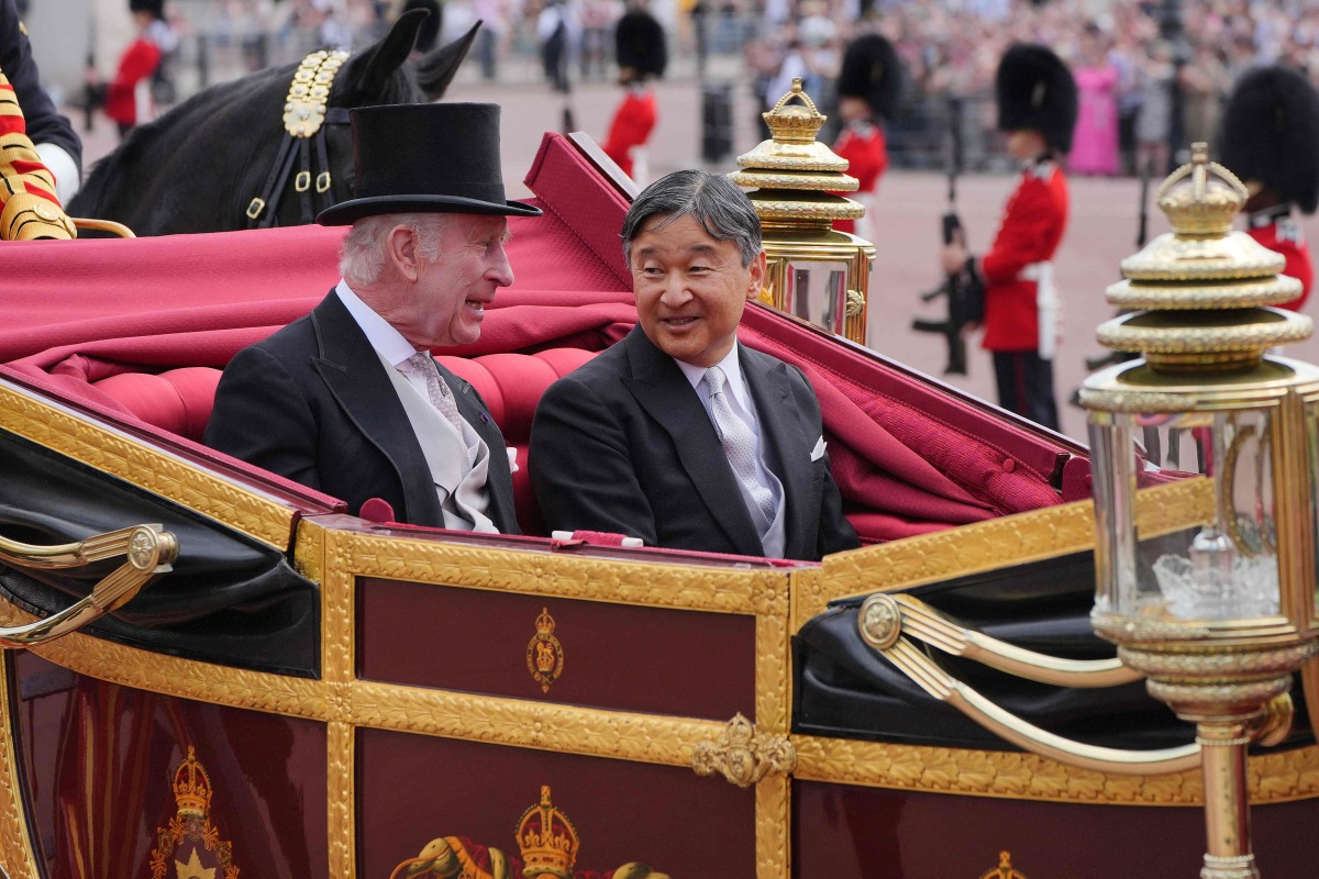 Britain's King Charles III and Japan's Emperor Naruhito travel in the 1902 State Landau Carriage following the Ceremonial Welcome at Horse Guards Parade in London on June 25, 2024, on the first day of their three-day State Visit to Britain.(Photo by Jonathan Brady / POOL / AFP)
