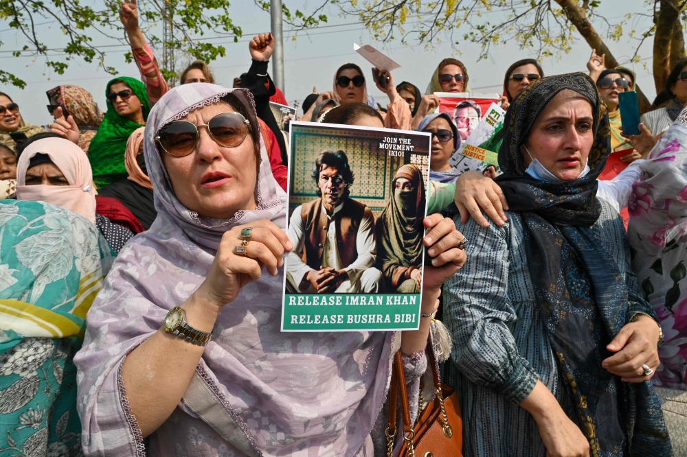 (Files) Pakistan's former prime minister Imran Khan's supporters protest outside the court in Islamabad on June 27, 2024. (Photo by Farooq Naeem / AFP)
