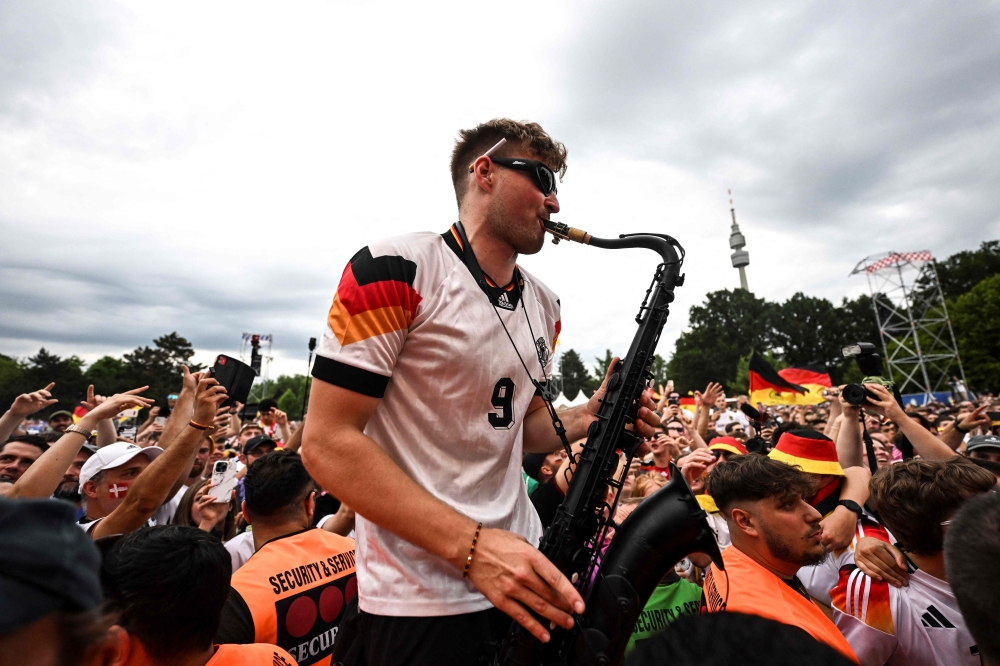 German saxophonist Andre Schnura performs for Germany supporters on June 29, 2024. (Photo by Patricia De Melo Moreira / AFP)