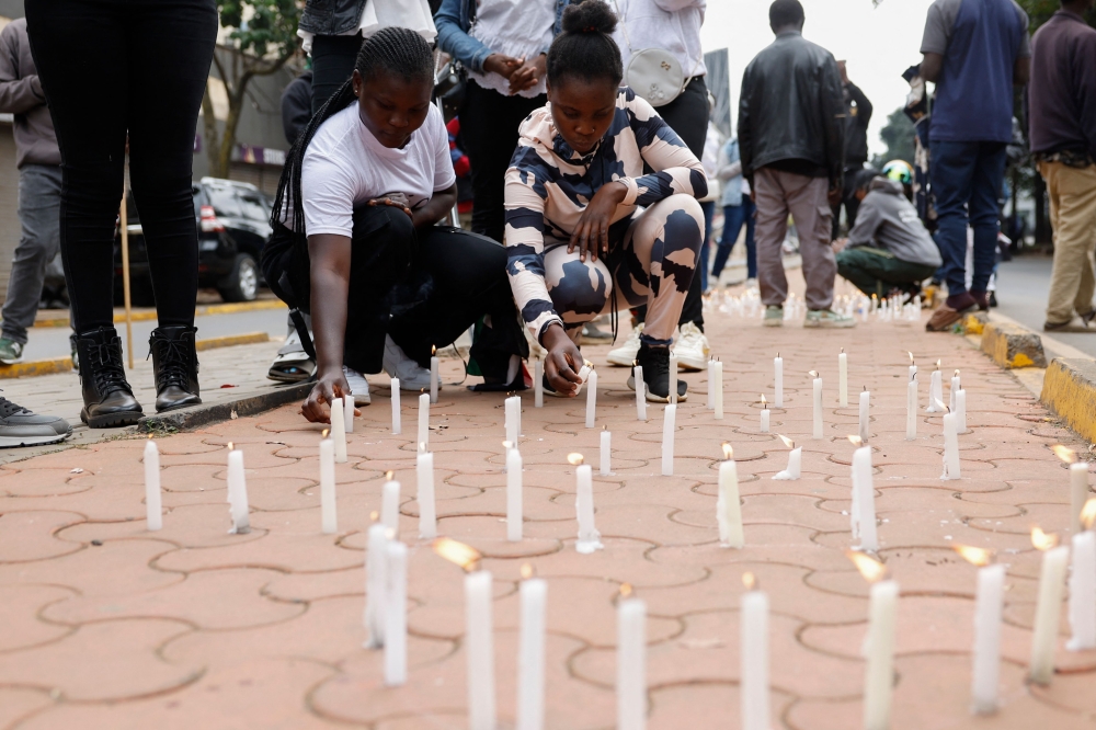 Kenyan youths light candles in memory of protesters killed during the nationwide deadly protest against a controversial now-withdrawn tax bill that left over 20 dead and shocked the East African nation, in Nairobi on June 30, 2024. (Photo by SIMON MAINA / AFP)
